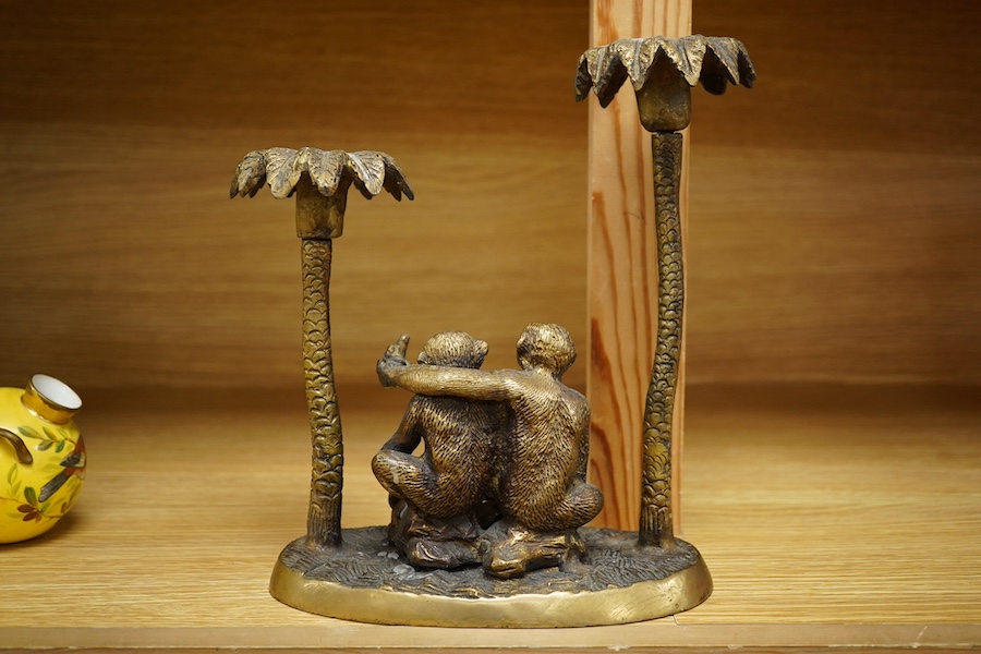 A brass two branch candleholder in the form of palm trees and monkeys, 22cm high. Condition - fair